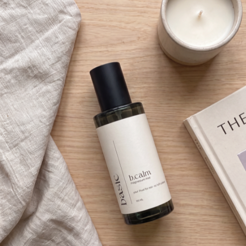 b.calm magnesium mist styled on linen with evening wind-down props