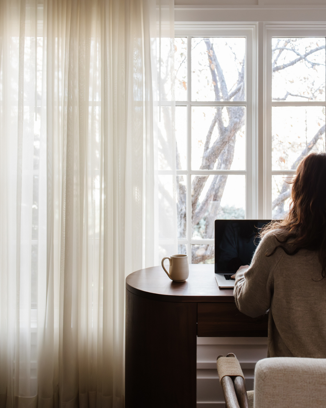 woman working desk using b.calm magnesium mist