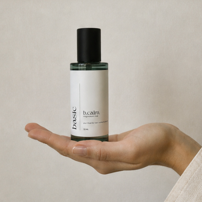 b.calm magnesium mist bottle held in hand to show size