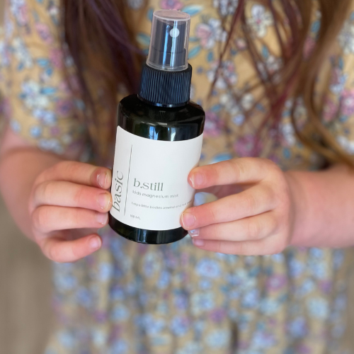 b.still kids magnesium mist bottle held in hand to show size