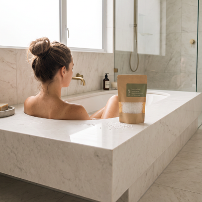 Pouring b.soothed bath soak into running bath water