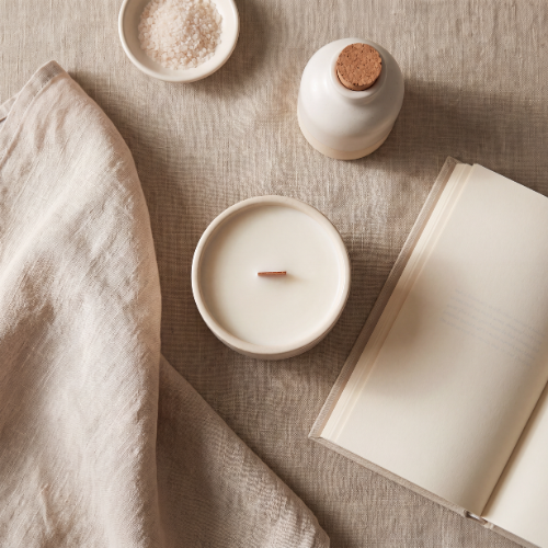 b.light Haven candle styled on linen with evening ritual props