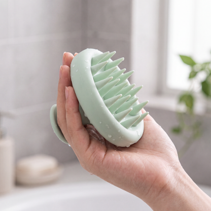 b.soft scalp brush held in hand to show size