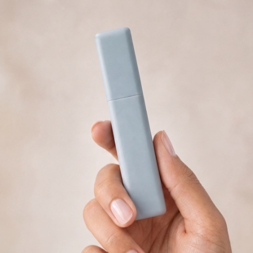 b.full lip plumping gloss held in hand to show size